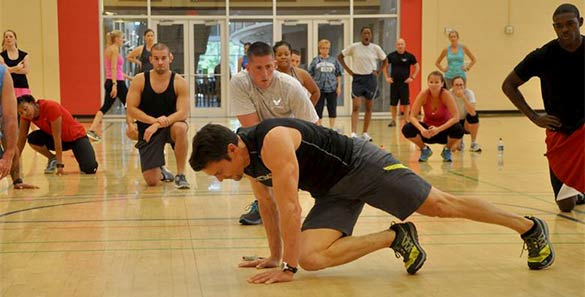  photo of fitness trainer helping customer with core strength exercise